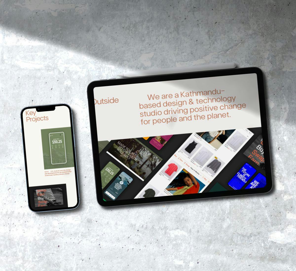 an iPhone and iPad demonstrating the responsive design of Outside Tech's website